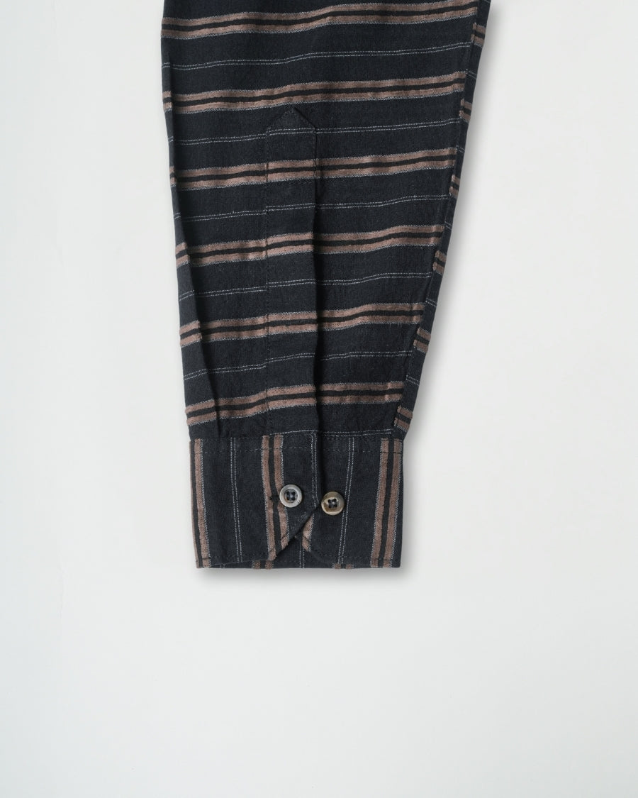 Striped shirt with button details on a light gray background
