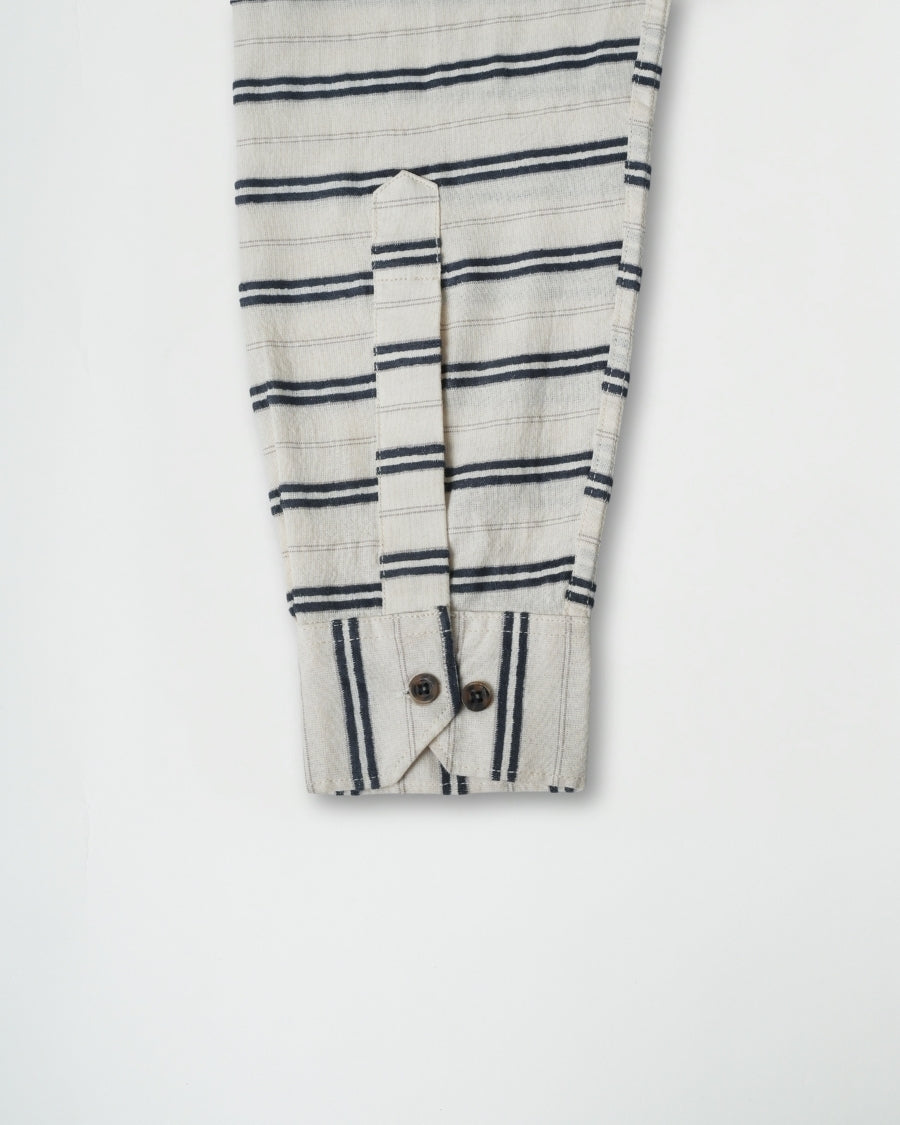 Striped shirt with buttons on a light gray background