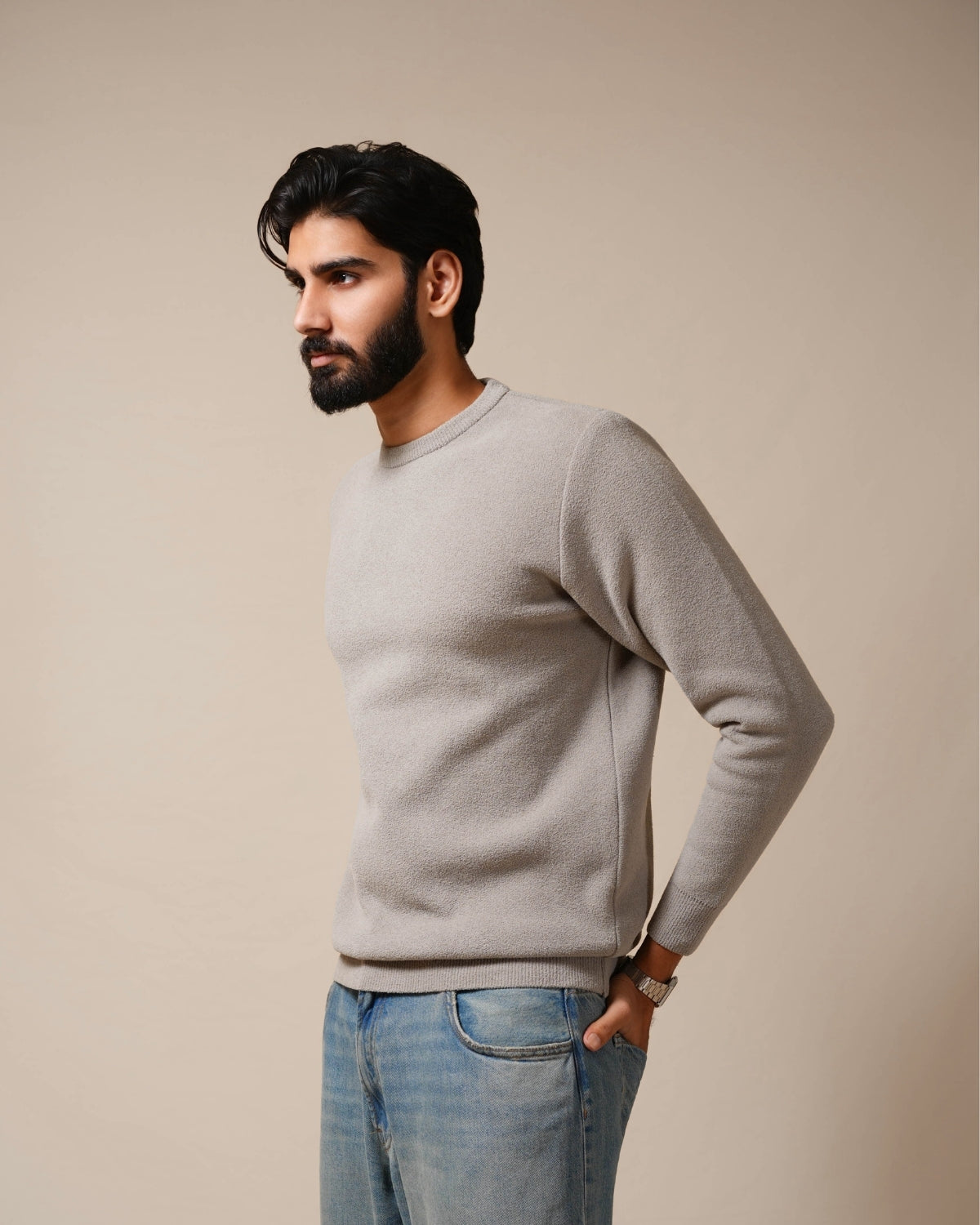Man wearing a burgundy ribbed sweater against a beige background