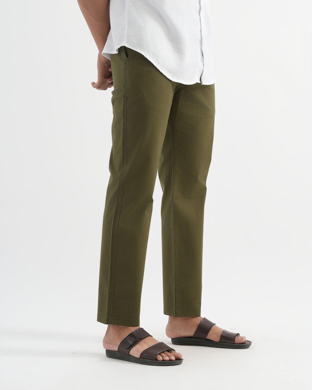 Person wearing olive green pants and white shirt on a white background