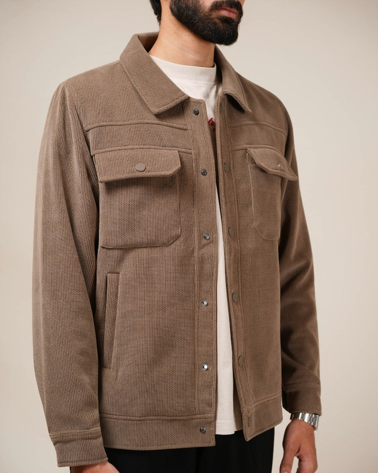 Brown corduroy jacket worn by a person on a neutral background