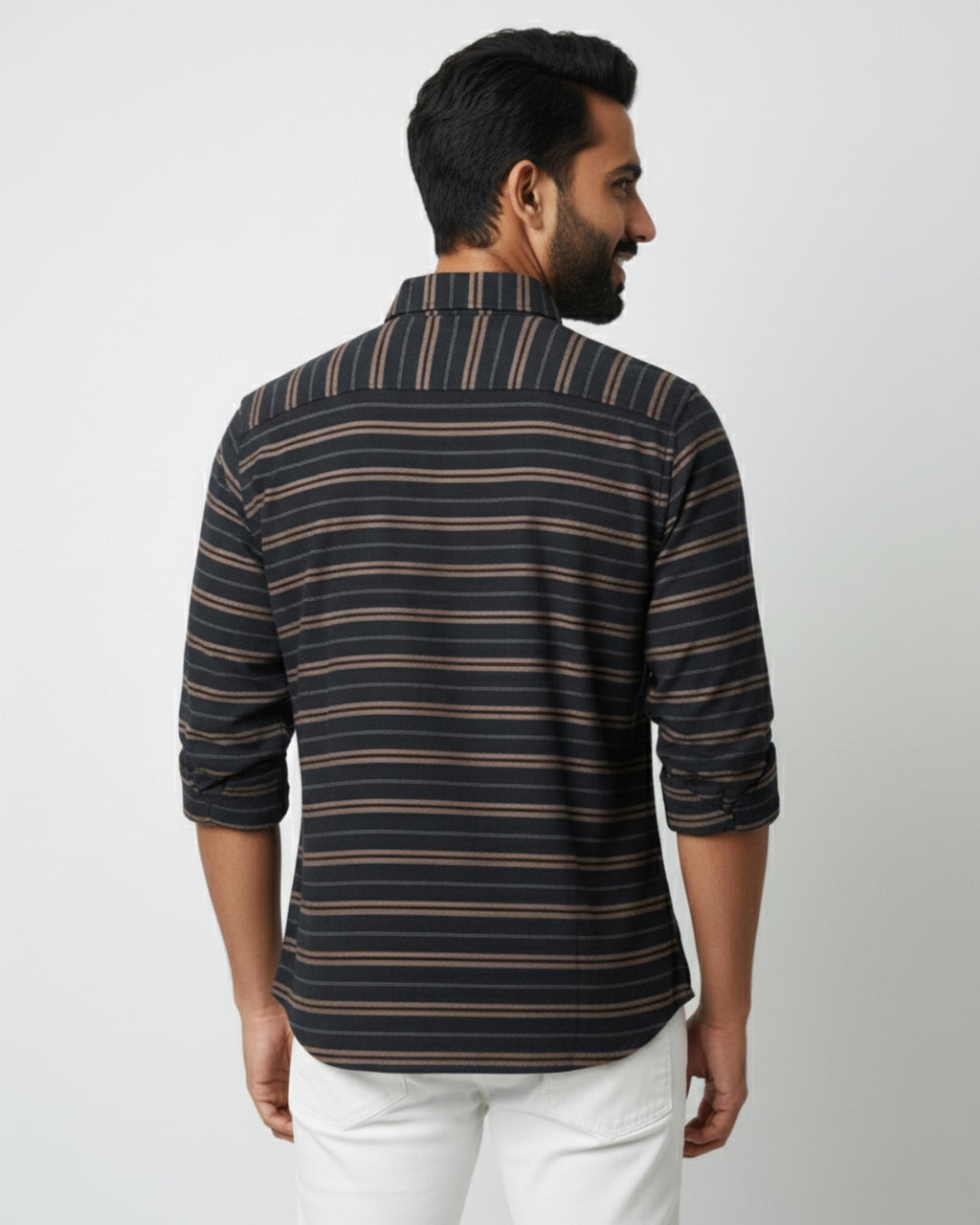 Man wearing a striped shirt with a plain background